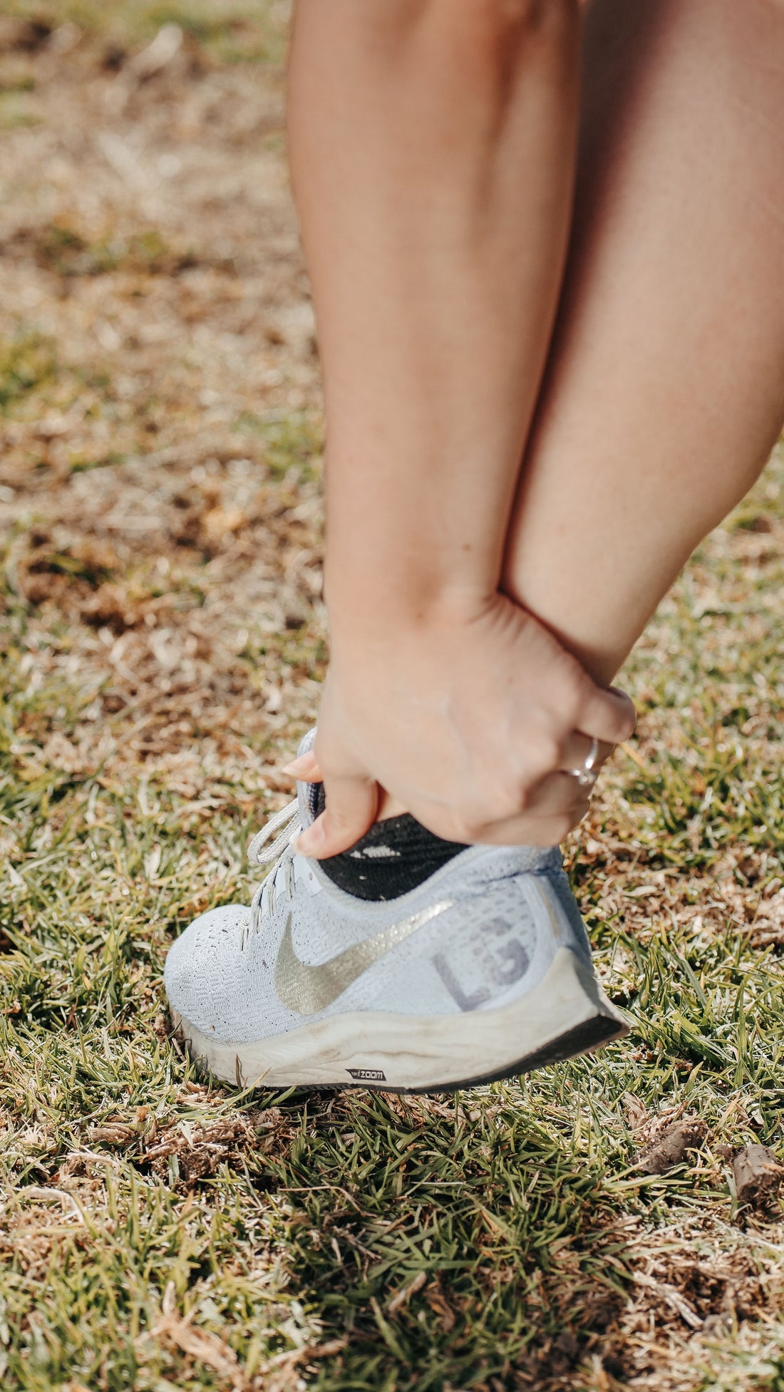 Person holding a painful ankle after a possible sprain