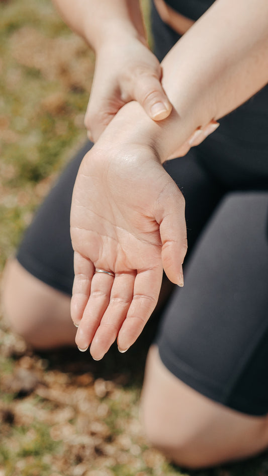 Person holding a painful wrist, a common symptom of carpal tunnel syndrome