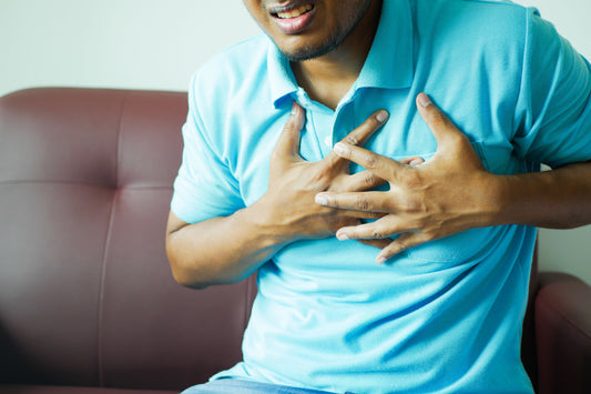 Man holding the front of his chest where costochondritis pain can occur