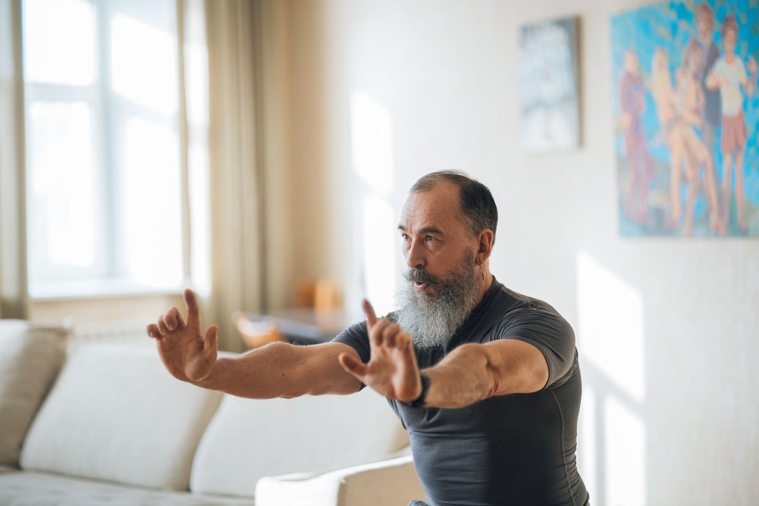 Older man practising a balance exercise at home