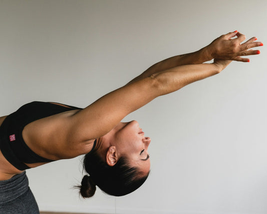 Woman gently stretching her shoulder and arms
